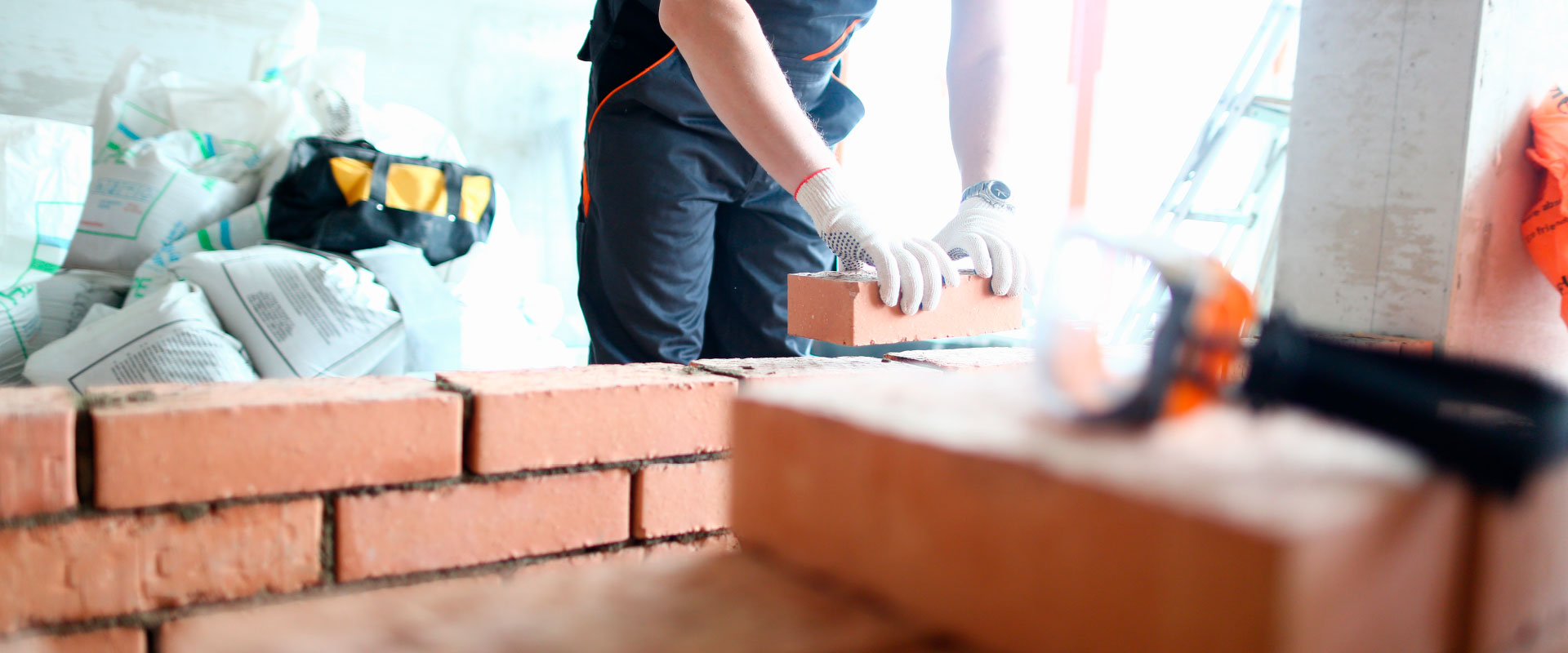 Brick layer building a wall